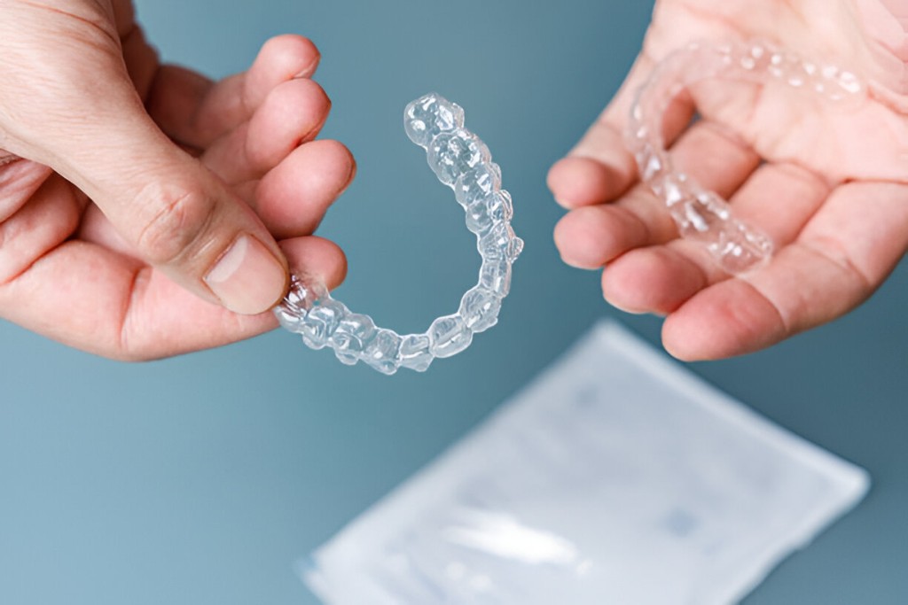 Dentist fitting Invisalign aligners on a patient, offering Invisalign in Keswick.