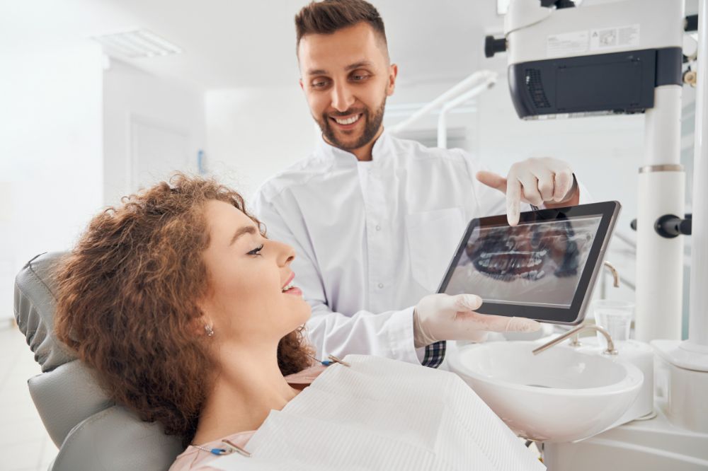 dentist using guided biofilm therapy to clean teeth